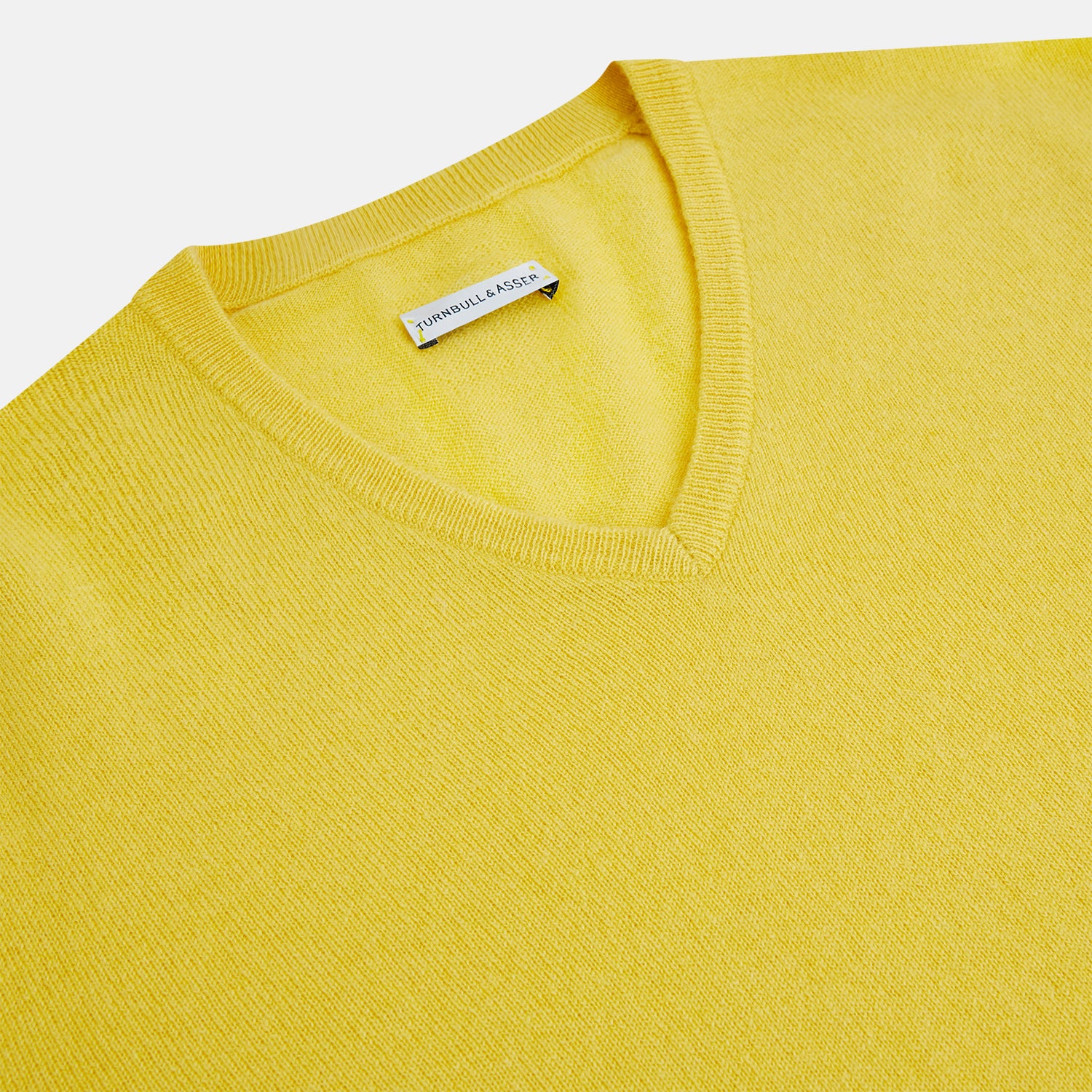 View 2 of product The Turnbull & Asser Canary Yellow Cashmere V-neck Jumper features long sleeves and ribbed cuffs and hem, shown against a white background.