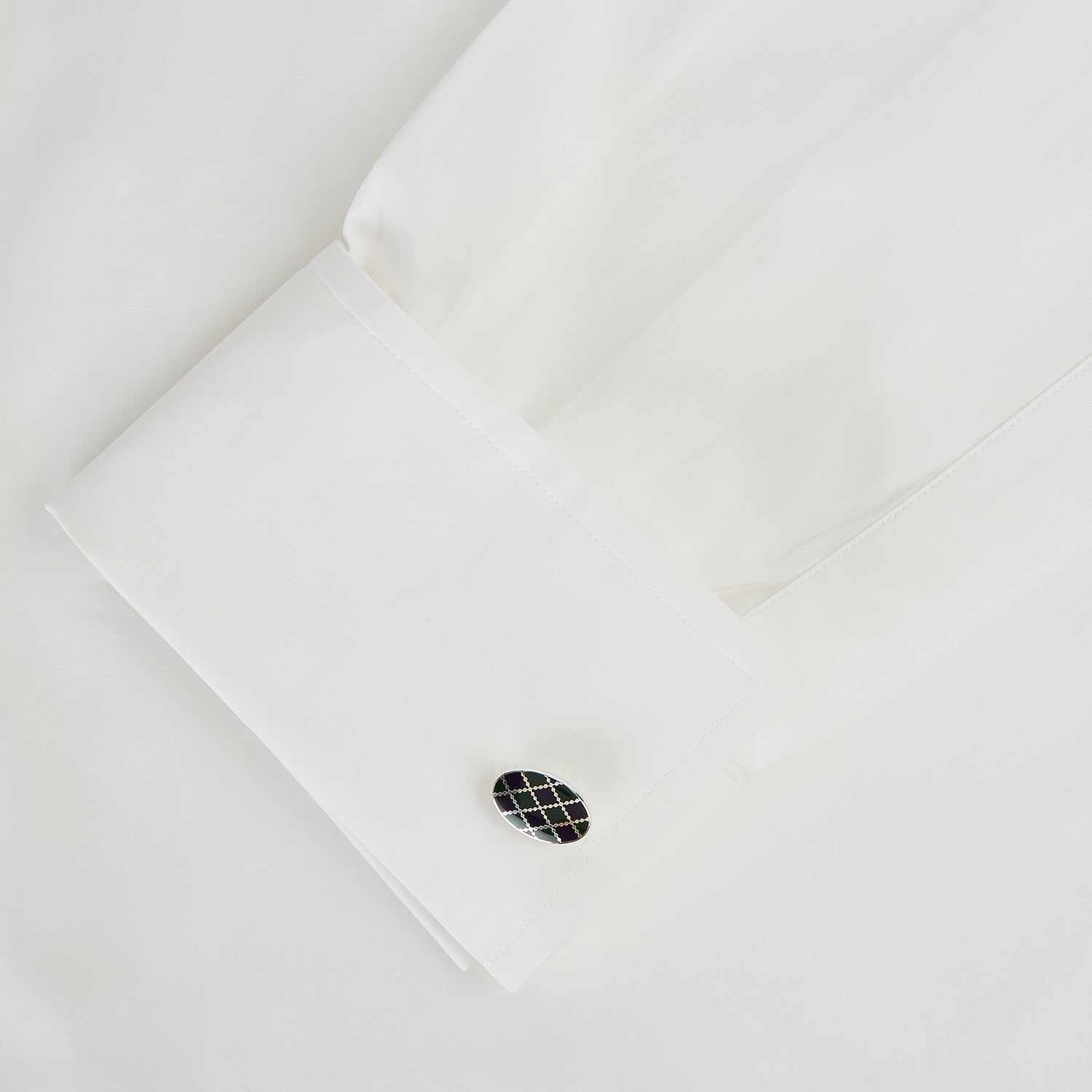 View 3 of product Turnbull & Asser's Forest Green and Navy Checkered Oval Enamel Cufflinks showcase masculine elegance with a sophisticated oval design and striking checkered enamel face.