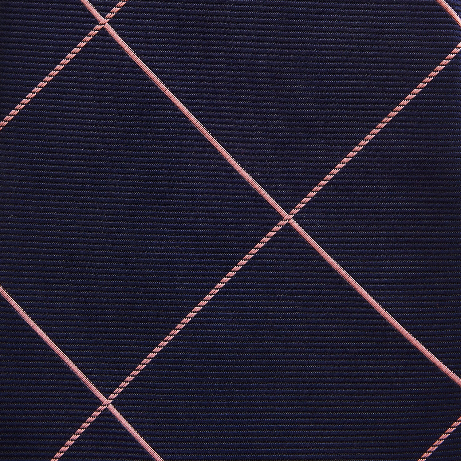 View 3 of product The Turnbull & Asser FONDANT PINK and WINDOW PANE NAVY Silk Tie features a subtle ribbed texture with a pink grid pattern on navy—an elegant choice for polished office attire, shown neatly rolled on a white background.