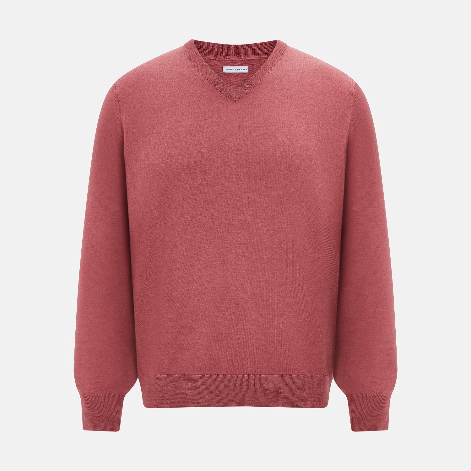 View 1 of product The Turnbull & Asser Antique Pink Merino V-Neck Jumper features ribbed cuffs, hem, and neckline in a soft antique pink, shown on a plain white background. Part of our knitwear collection.