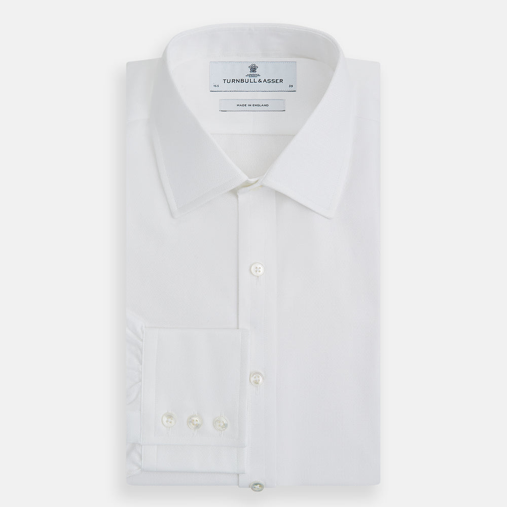 The Turnbull & Asser White Herringbone Mayfair Shirt features long sleeves and a classic collar—a timeless wardrobe essential, shown here against a white background.
