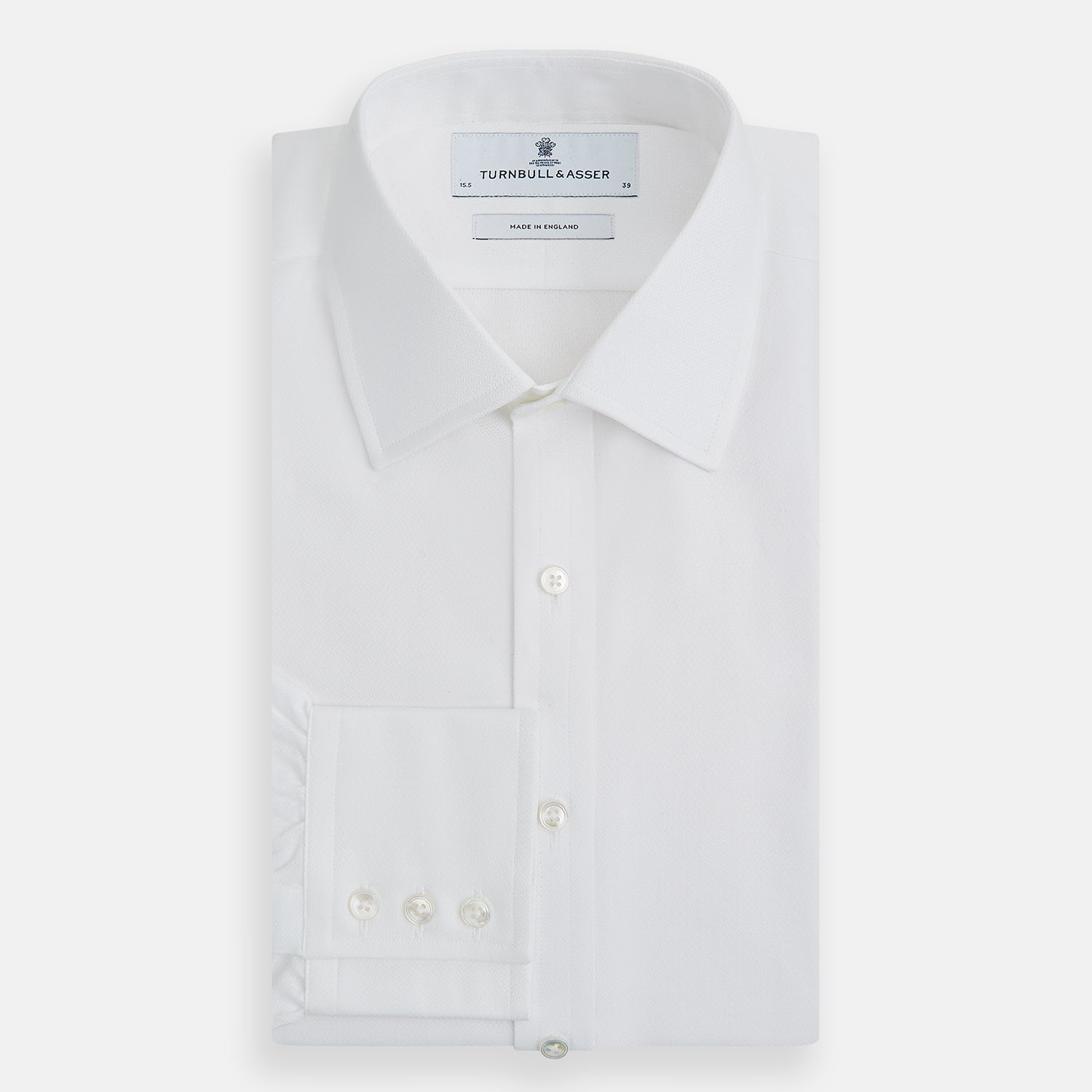 View 5 of product The Turnbull & Asser White Herringbone Mayfair Shirt features long sleeves and a classic collar—a timeless wardrobe essential, shown here against a white background.