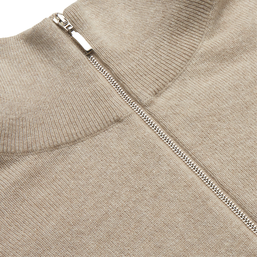 The Beige Lennox Half-Zip Jumper by Turnbull & Asser is a stylish cashmere knit with long sleeves, high collar, and half-length front zipper, finished with ribbed cuffs and hem. Shown against a plain white background.
