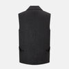 View 3 of product The Turnbull & Asser Ash Collared Linen Waistcoat is a sleeveless dark gray piece with a button-down front, two zippered side pockets, and a small chest pocket, shown against a plain white background.
