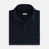 View 4 of product The Turnbull & Asser Navy Polo Shirt features short sleeves, a collar, three-button placket, and a single buttoned chest pocket, shown flat on a plain white background.