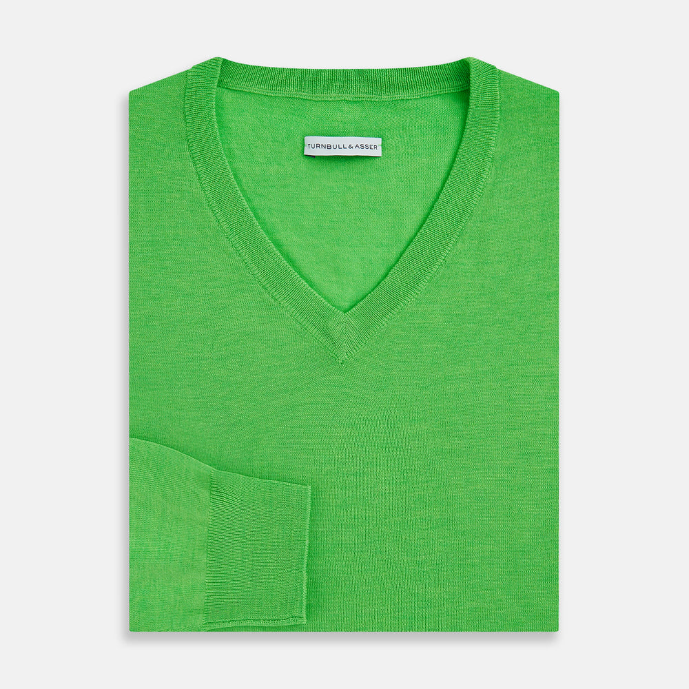 The Turnbull & Asser Lime Green Fine Merino V-Neck Jumper features ribbed cuffs and hem—a vibrant, standout knitwear choice for any wardrobe.