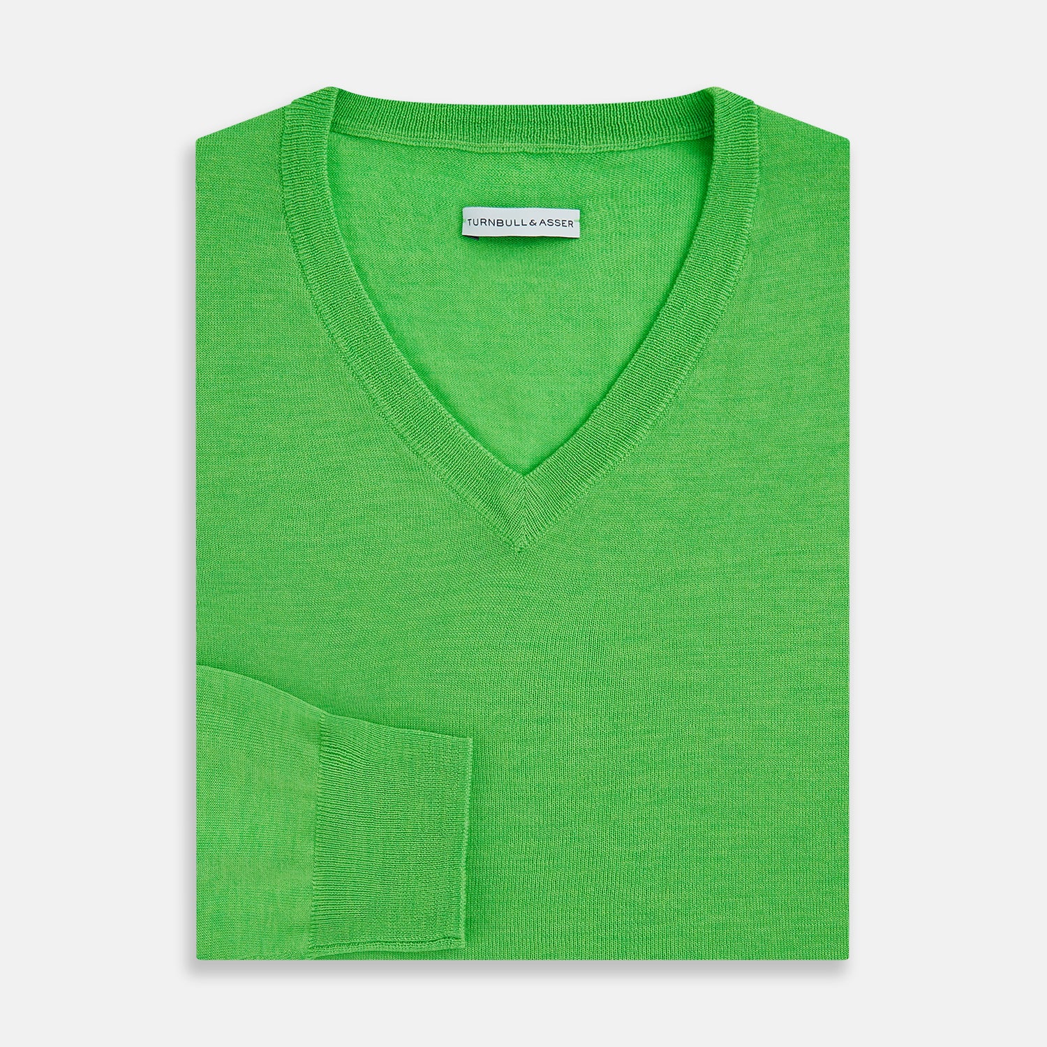 View 4 of product The Turnbull & Asser Lime Green Fine Merino V-Neck Jumper features ribbed cuffs and hem—a vibrant, standout knitwear choice for any wardrobe.