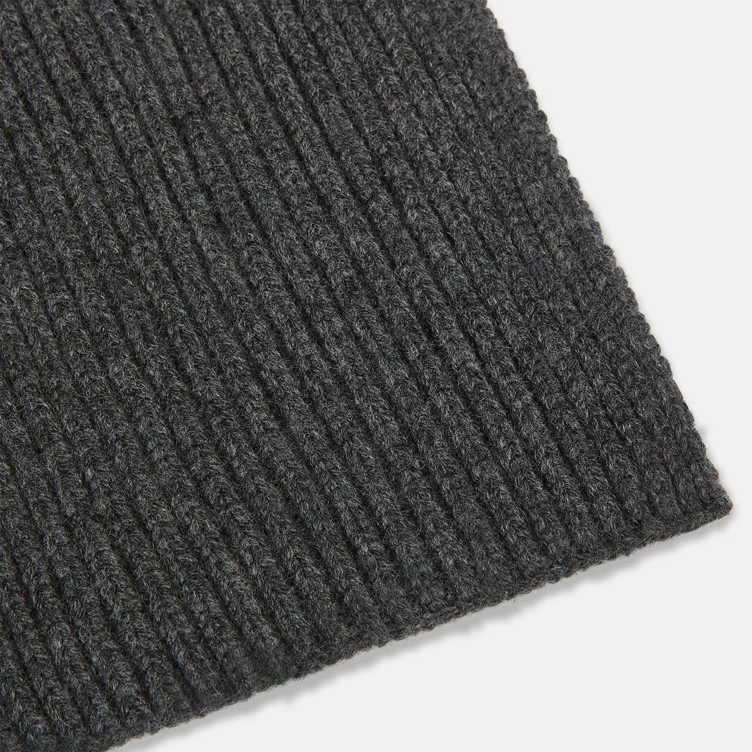 View 2 of product The Turnbull & Asser Graphite Rib-Knit Cashmere Scarf, a luxury winter accessory, is shown neatly looped against a plain white background.