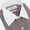 View 2 of product The Turnbull & Asser Light Porto Red Track Stripe Shirt features a Mayfair fit and contrast white T&A collar and cuffs, with vertical blue stripes on mauve, exemplifying British craftsmanship.