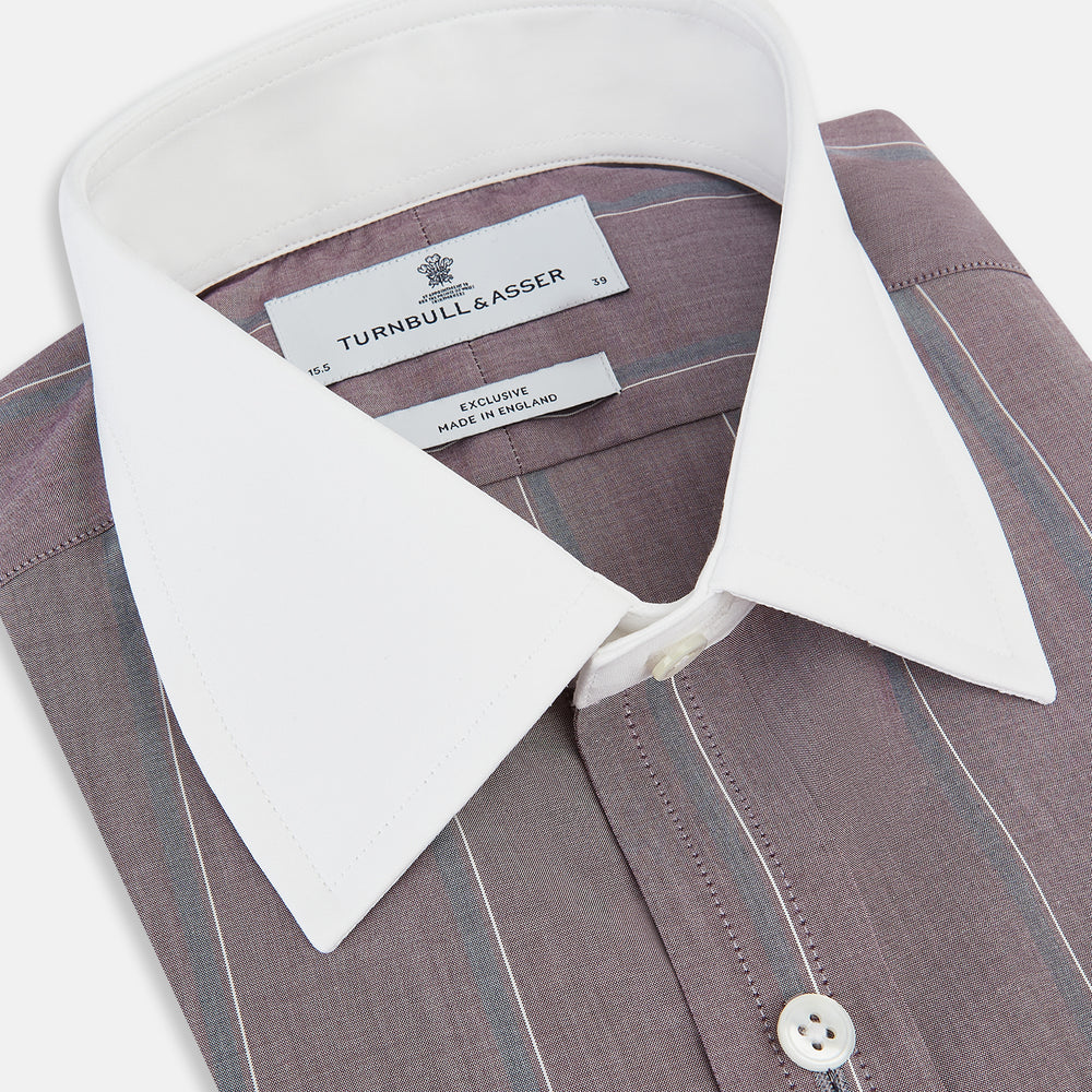 The Turnbull & Asser Light Porto Red Track Stripe Shirt features a Mayfair fit and contrast white T&A collar and cuffs, with vertical blue stripes on mauve, exemplifying British craftsmanship.