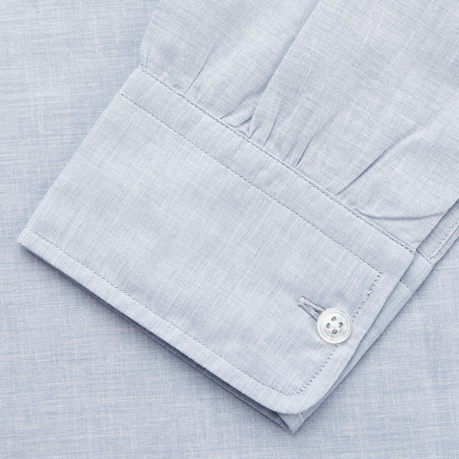 View 3 of product Turnbull & Asser’s Pale Blue Linen Blend Weekend Fit Unwin Shirt features long sleeves, a band collar, two chest pockets, and white buttons—ideal for casual summer wear.