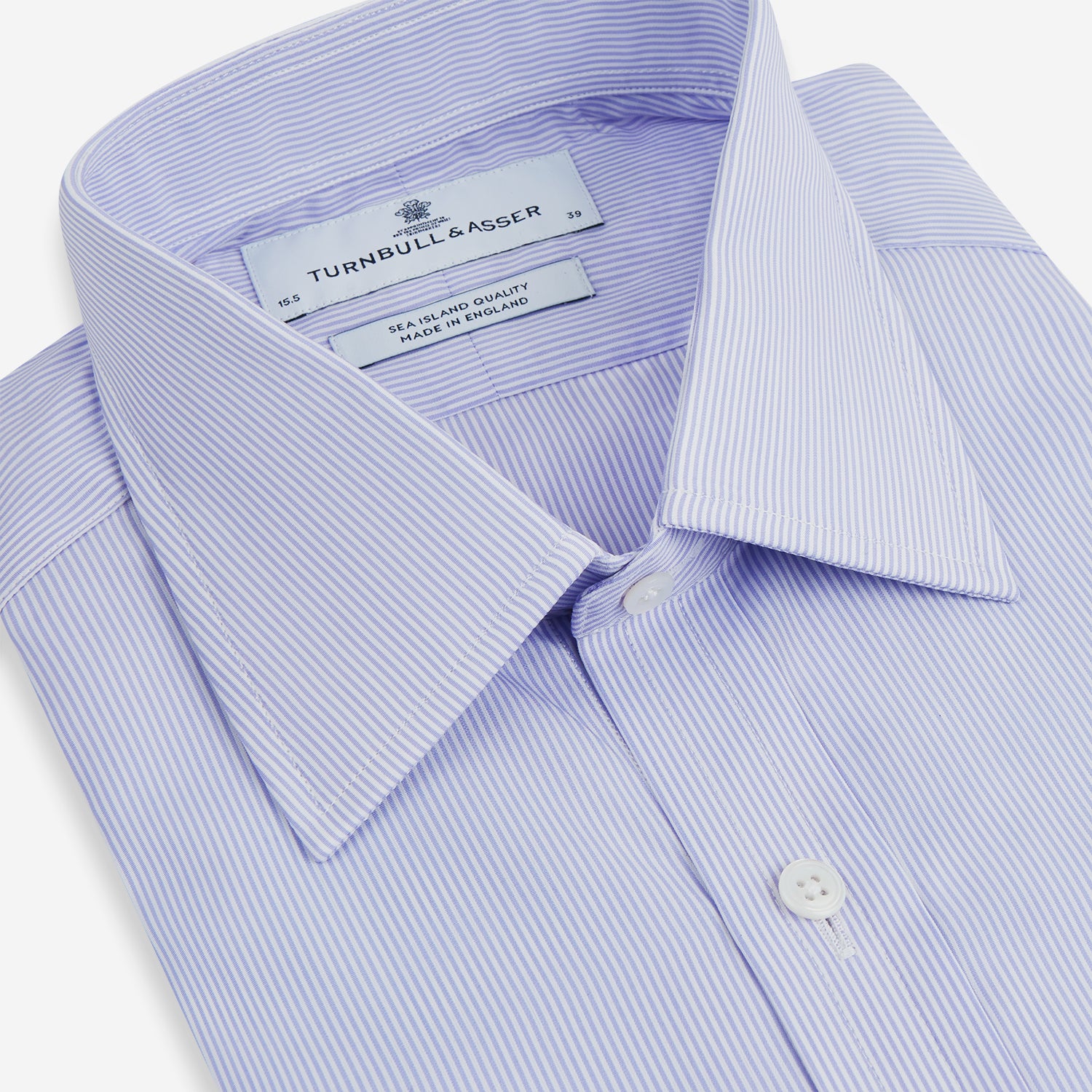 View 2 of product A Blue and White Fine Bengal Stripe Sea Island Quality Cotton Shirt by Turnbull & Asser, featuring a T&A collar and 3-button cuffs, is laid flat on a white background.