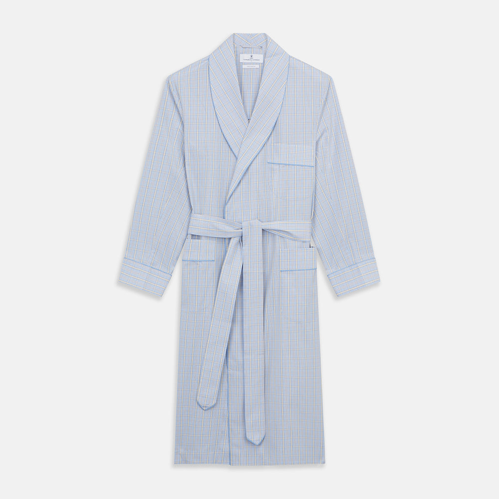 The Turnbull & Asser Blue and Yellow Check Poplin Cotton Dressing Gown features long sleeves, a shawl collar, front pockets, and a matching belt at the waist, shown on a plain white background.