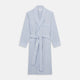 The Turnbull & Asser Blue and Yellow Check Poplin Cotton Dressing Gown features long sleeves, a shawl collar, front pockets, and a matching belt at the waist, shown on a plain white background.