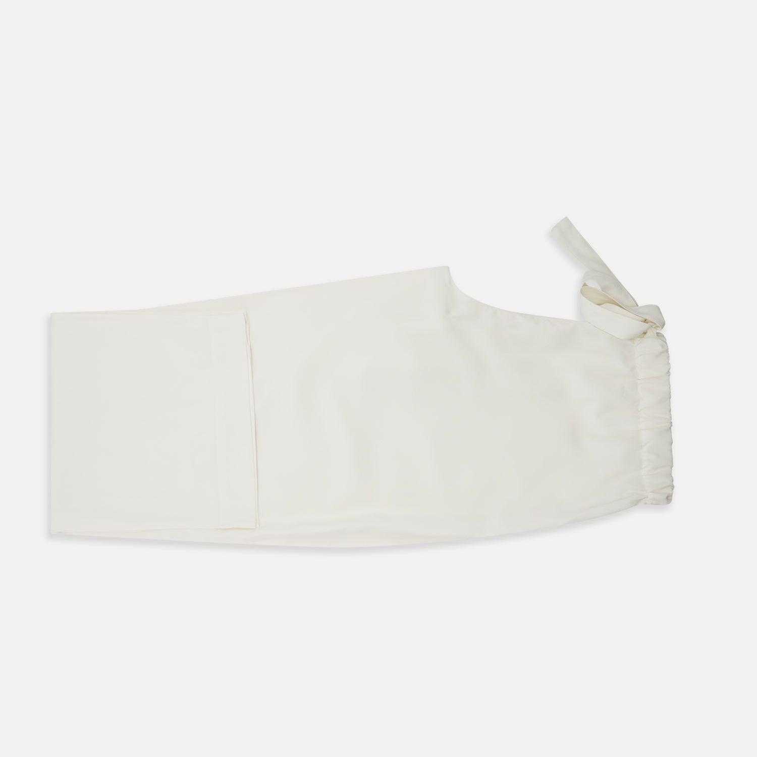 View 7 of product The Women's Harriet Cream Silk Pyjama Set by Turnbull & Asser features a white sand-washed silk button-up top with black piping and chest pocket, plus matching drawstring pants, all shown against a white background.