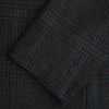 View 4 of product The Turnbull & Asser Charcoal Glen Check Sports Jacket features a dark plaid pattern, single-button closure, notched lapels, and two front flap pockets, shown against a plain white background—an essential for any men's wardrobe.
