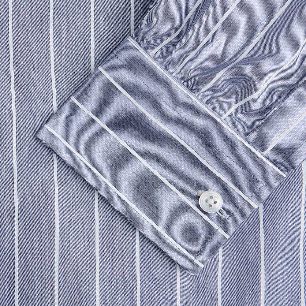 The Turnbull & Asser Pale Blue and White Pinstripe Cotton Blend Weekend Fit Finch Shirt features long sleeves, a chest pocket, and white buttons—ideal for classic, casual style. Shown laid flat on a white background.