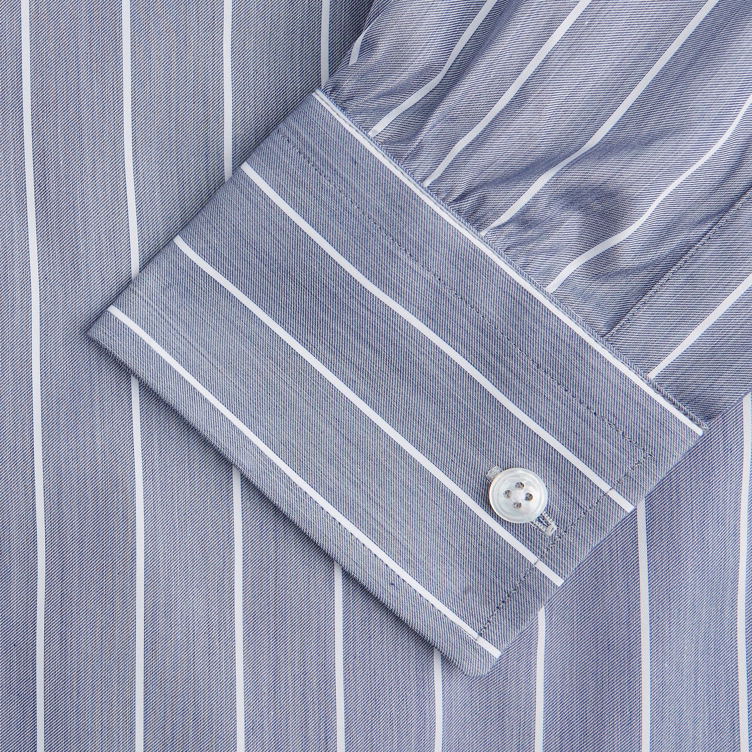 View 2 of product The Turnbull & Asser Pale Blue and White Pinstripe Cotton Blend Weekend Fit Finch Shirt features long sleeves, a chest pocket, and white buttons—ideal for classic, casual style. Shown laid flat on a white background.