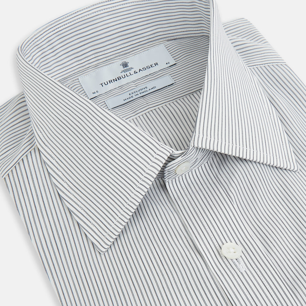 A long-sleeved Midnight Blue Fine Track Stripe Mayfair Shirt by Turnbull & Asser, featuring a T&A collar and white buttons, is laid neatly flat on a white background.