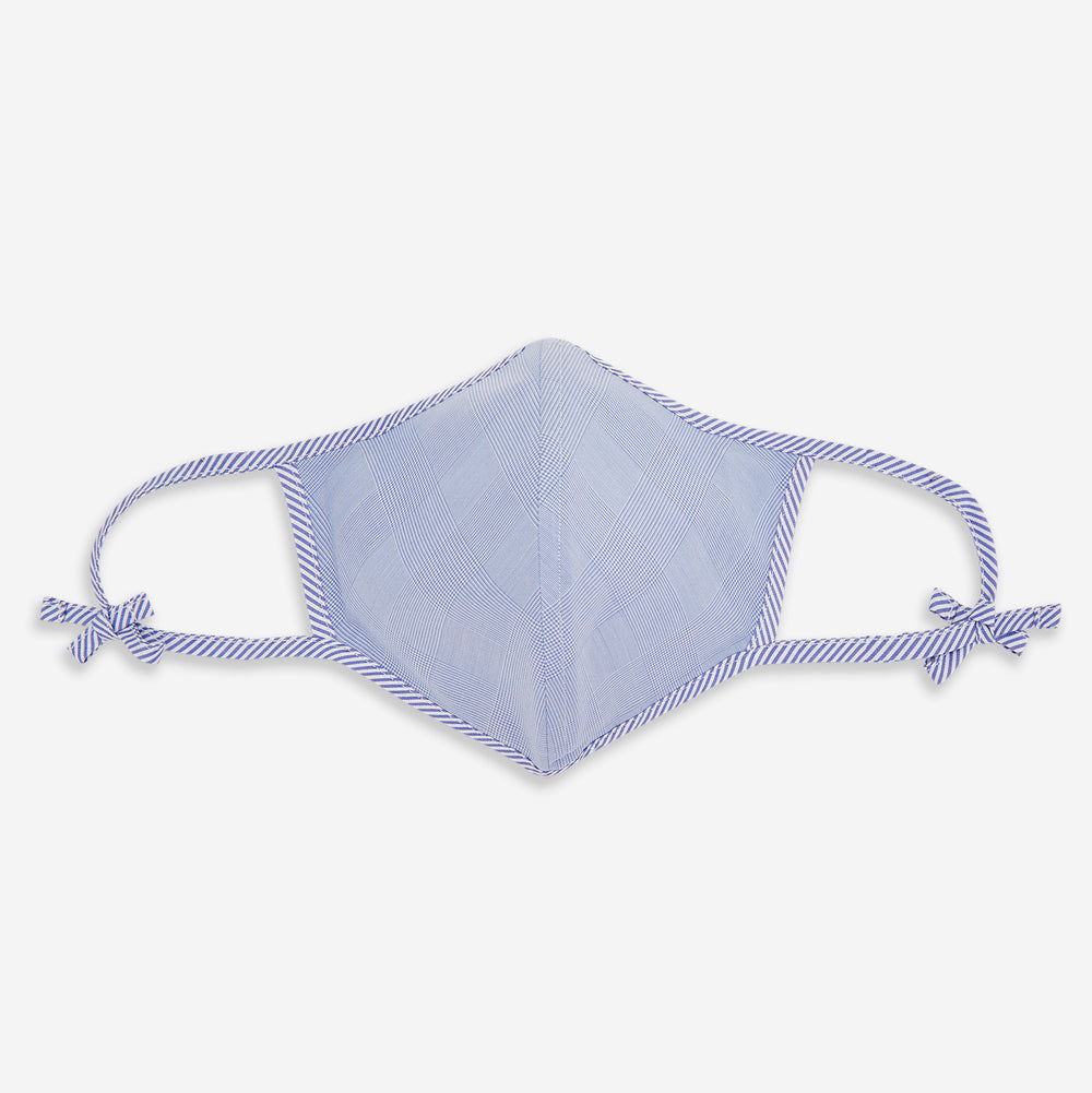 The Turnbull & Asser Blue Fine Check Zephyr Cotton Commuter Mask features a light blue and white check pattern, adjustable side ties, and comes with 3 Viroformula™ filters. Shown on a plain white background.