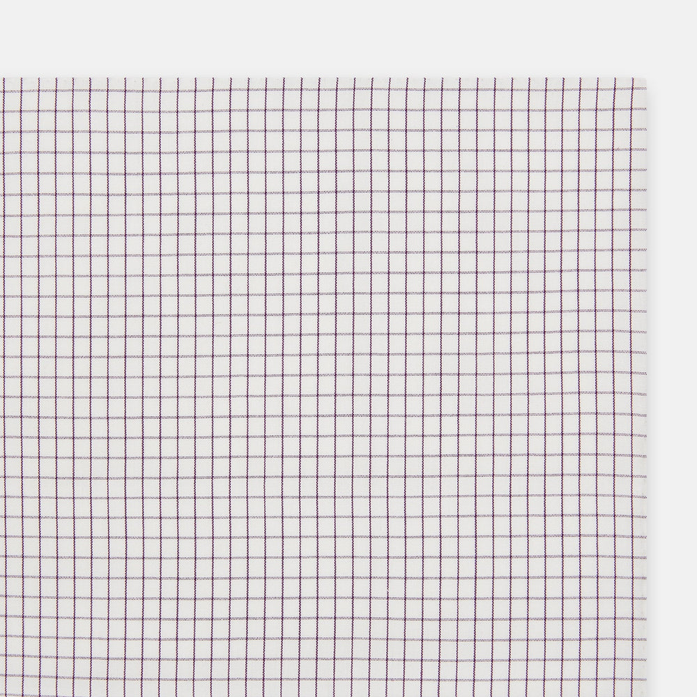 The Turnbull & Asser Hand Rolled Purple Graph Check Handkerchief features a white cloth with evenly spaced thin purple lines forming small squares, neatly laid flat against a white background.