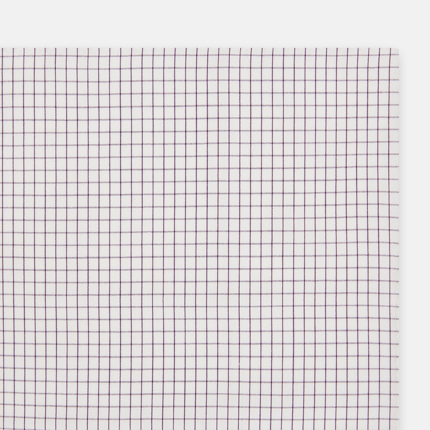 View 7 of product The Turnbull & Asser Hand Rolled Purple Graph Check Handkerchief features a white cloth with evenly spaced thin purple lines forming small squares, neatly laid flat against a white background.