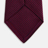 View 4 of product The HOUNDSTOOTH NAVY BURGUNDY TIE by Turnbull & Asser features a textured navy and burgundy silk woven pattern—an elegant staple for every gentleman’s wardrobe.