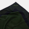 View 2 of product The Turnbull & Asser Navy and Kelly Green Dot Silk Pocket Square features small green dots on navy silk and a folded corner displaying the reverse—an elegant, handmade accessory perfect for enhancing any formal attire.