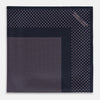 View 3 of product The Turnbull & Asser Navy and Pink Dot Silk Pocket Square features small pink dots and a solid border, with one corner folded to display both sides—an elegant accessory that reflects fine handmade craftsmanship.