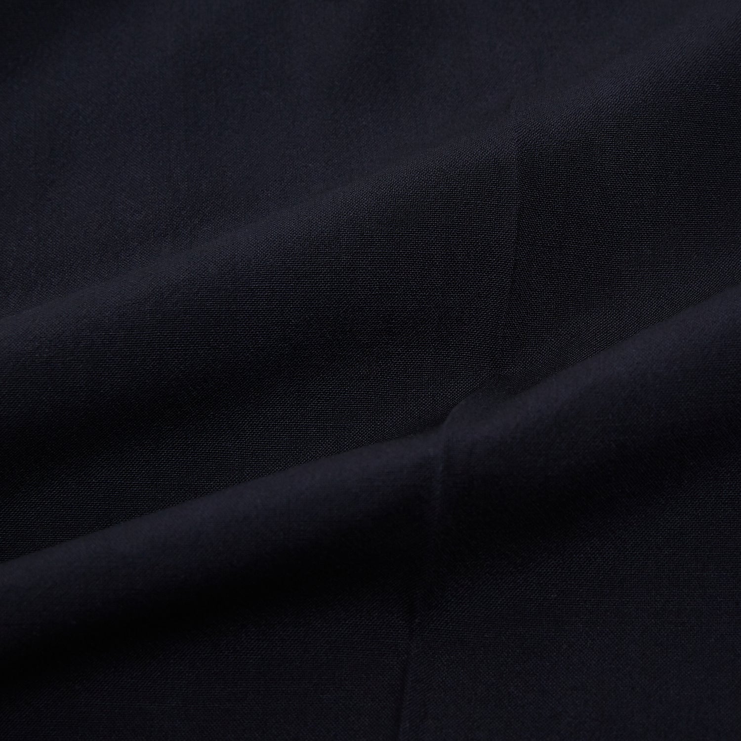 View 7 of product A pair of Midnight Blue Wool Henry Trousers by Turnbull & Asser, with a button closure and straight legs, shown against a plain white background.