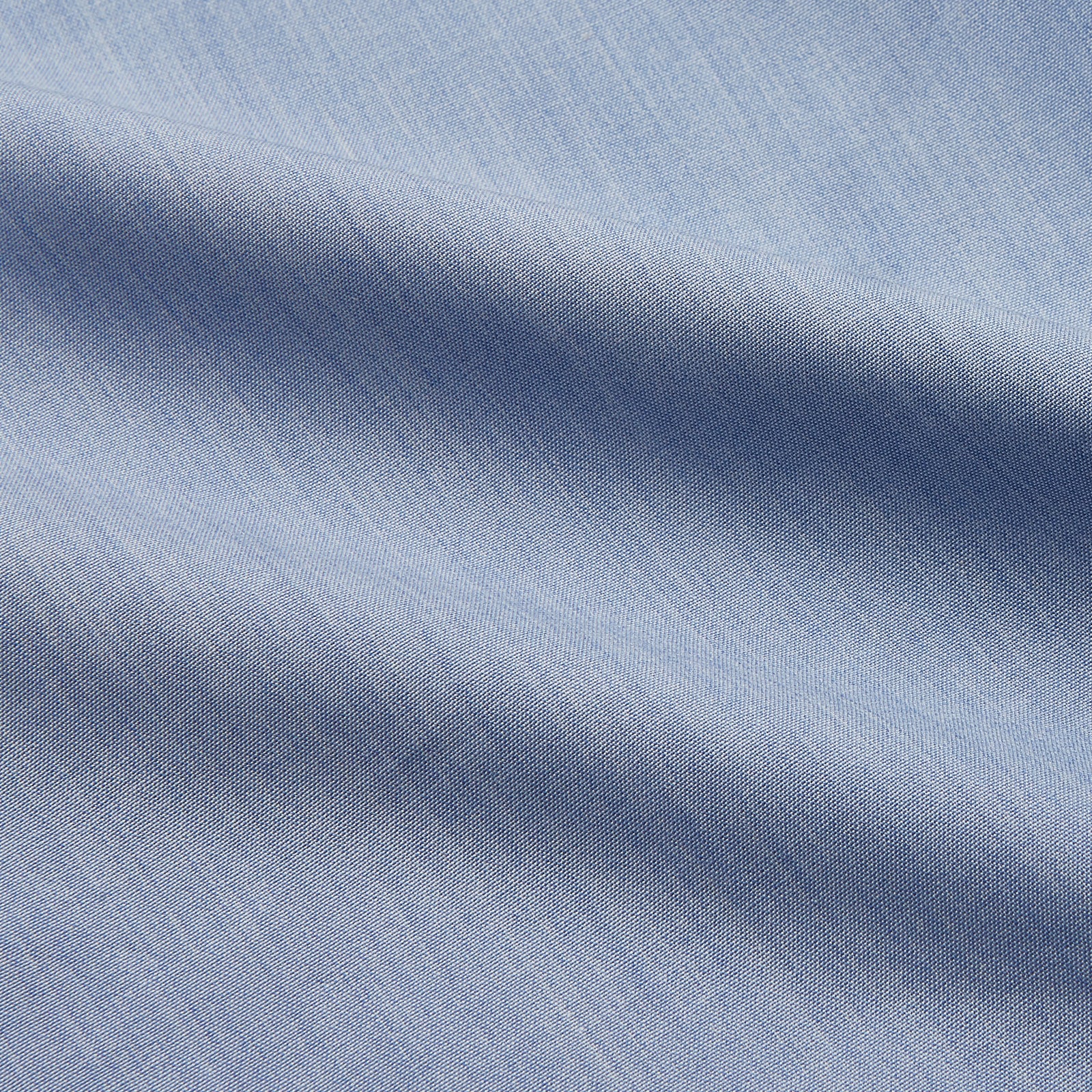 View 4 of product The Turnbull & Asser Slate Blue Chambray Holiday Fit Fellows Shirt features long sleeves and a classic collar, laid flat on a white background—a versatile summer piece for any occasion.