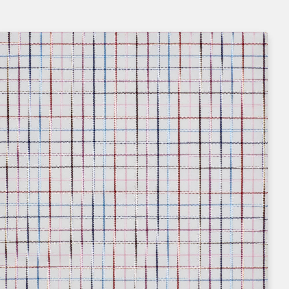 The Turnbull & Asser Hand Rolled Multi Graph Check Handkerchief features a white cotton base with thin red, blue, and purple intersecting lines forming a check pattern, neatly folded with stitched edges for an elegant gentleman's accessory.