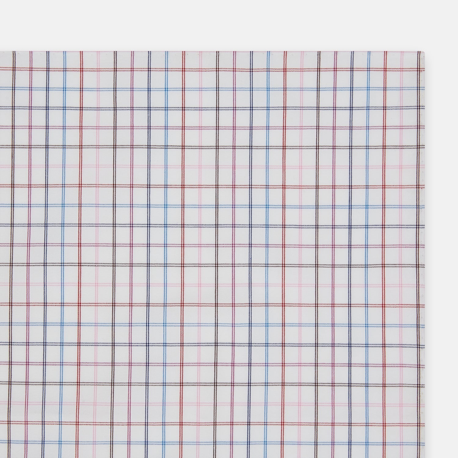 View 2 of product The Turnbull & Asser Hand Rolled Multi Graph Check Handkerchief features a white cotton base with thin red, blue, and purple intersecting lines forming a check pattern, neatly folded with stitched edges for an elegant gentleman's accessory.