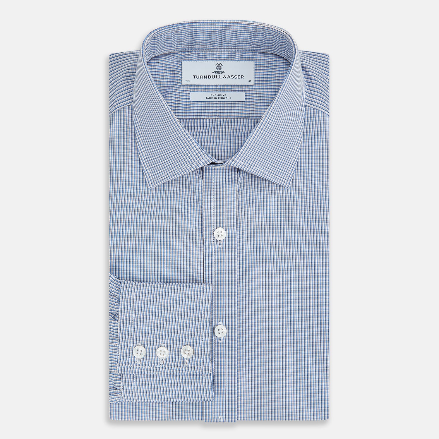 View 5 of product The Turnbull & Asser Pale Blue Micro Graph Check Mayfair Shirt features a small blue and white check pattern, classic T&A collar, white buttons, and buttoned cuffs. Presented on a plain white background.
