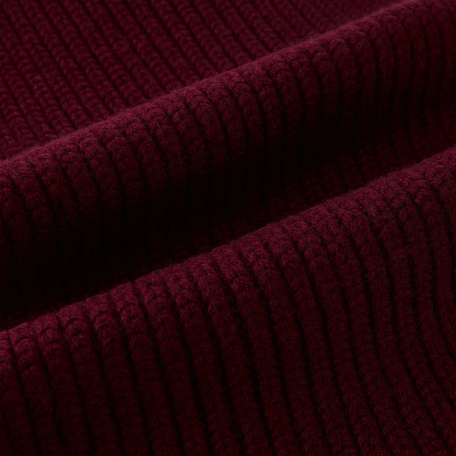 View 3 of product The Burgundy Rib-Knit Cashmere Scarf by Turnbull & Asser is crossed at the center and set against a plain light gray background—an elegant, luxurious winter accessory.
