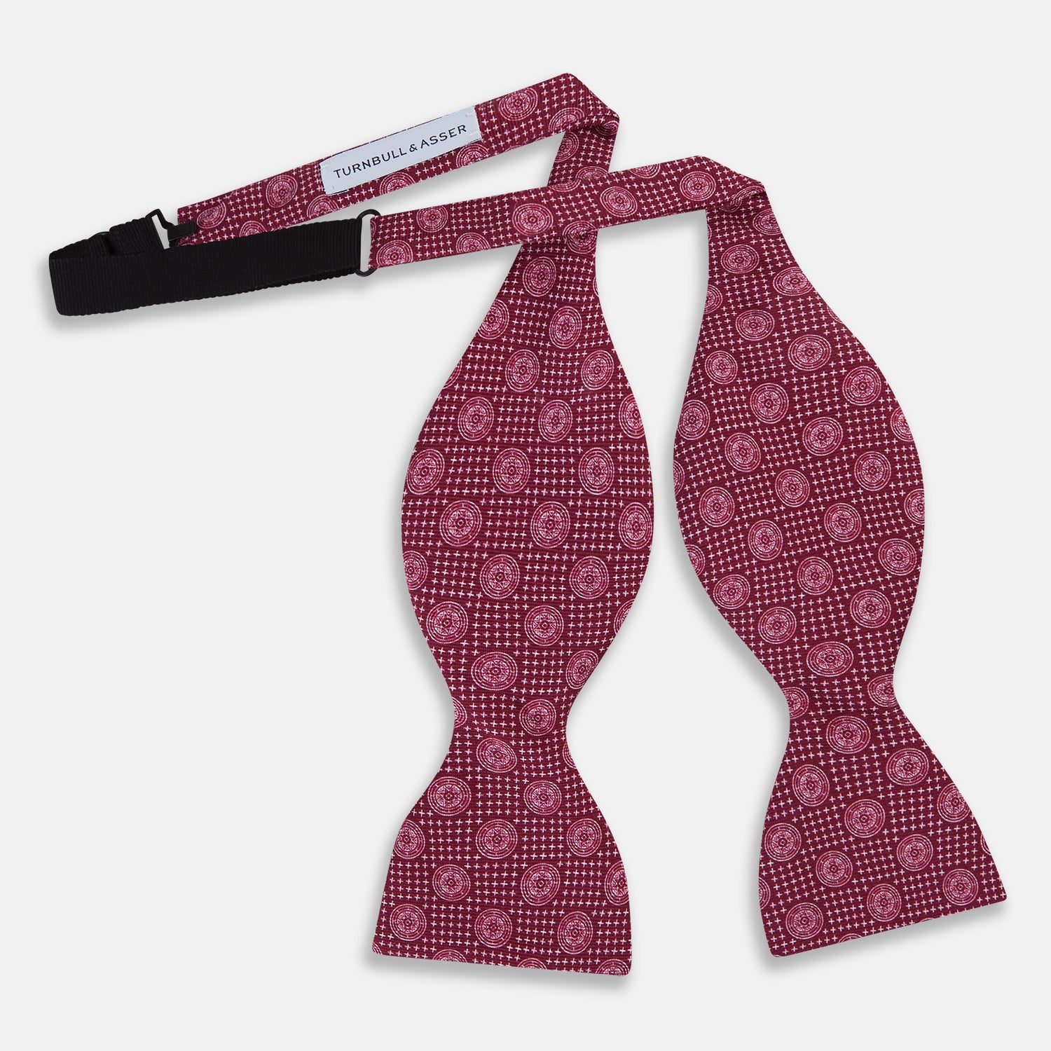 View 2 of product The Turnbull & Asser Burgundy Medallion Silk Bow Tie, featuring small white circles and crosshatch lines, is displayed on a plain white background—perfect for adding sophistication to smart attire.
