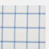 View 3 of product The Turnbull & Asser Colony Blue Grid Check Hand-Rolled Handkerchief features a white base with intersecting light and dark blue plaid lines forming squares, shown folded on a plain white background.