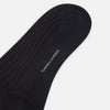 View 3 of product The Turnbull & Asser Smoke Mid-Length Sock, in black with a ribbed design, is displayed upright on a white background to highlight its refined comfort and coverage from toe to cuff.