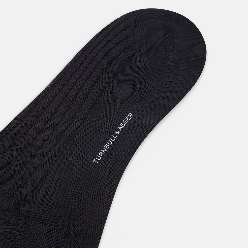 The Turnbull & Asser Smoke Mid-Length Sock, in black with a ribbed design, is displayed upright on a white background to highlight its refined comfort and coverage from toe to cuff.