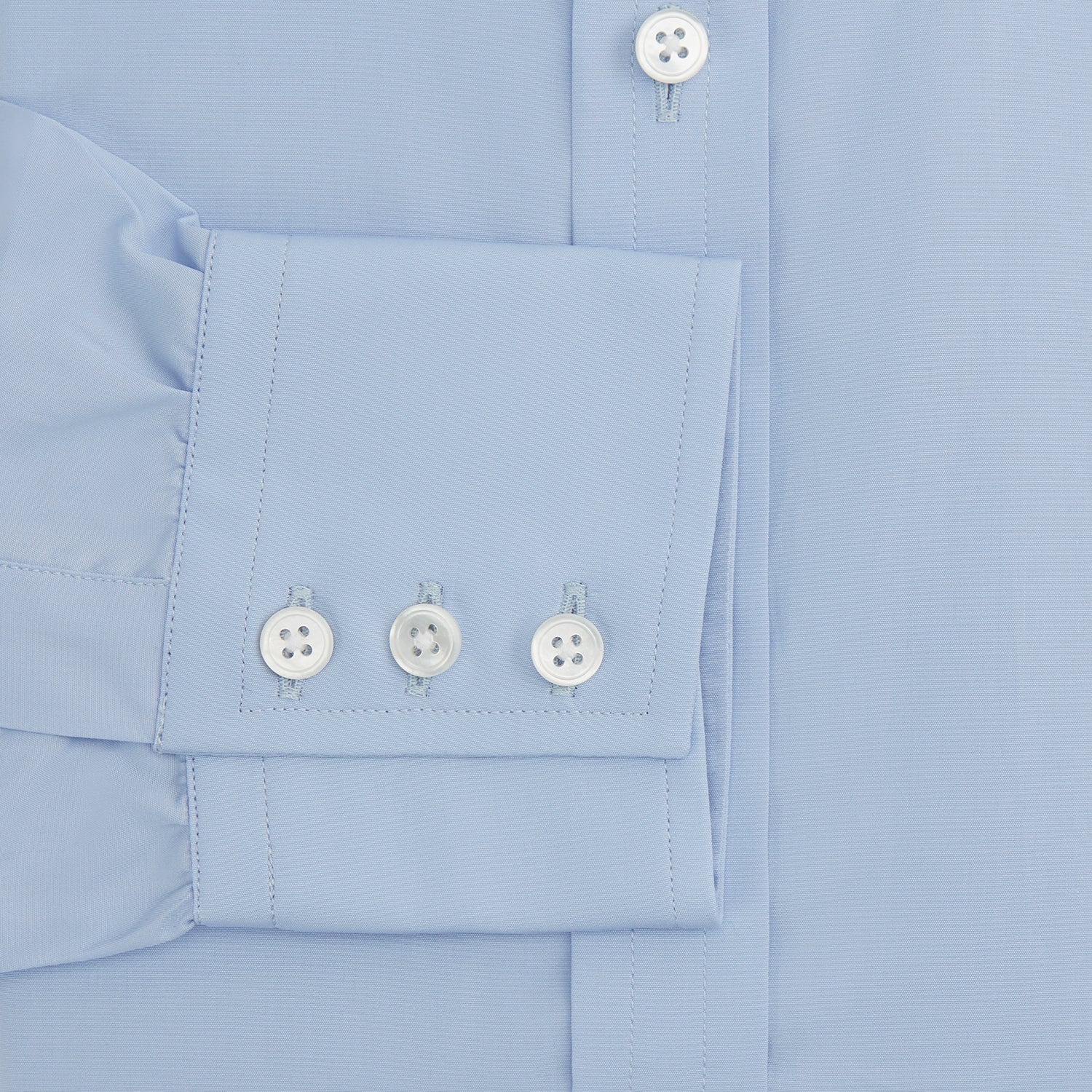 View 3 of product The Turnbull & Asser Blue Cotton Shirt features a T&A collar, 3-button cuffs, and white buttons—ideal for navy suits or smart looks. Laid flat on a white background.