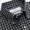 View 3 of product The Turnbull & Asser Black Multi Check Cotton Blend Weekend Fit Hayne Shirt features a Dorset button-down collar and white buttons, with a black and white plaid pattern, shown laid flat on a white background.
