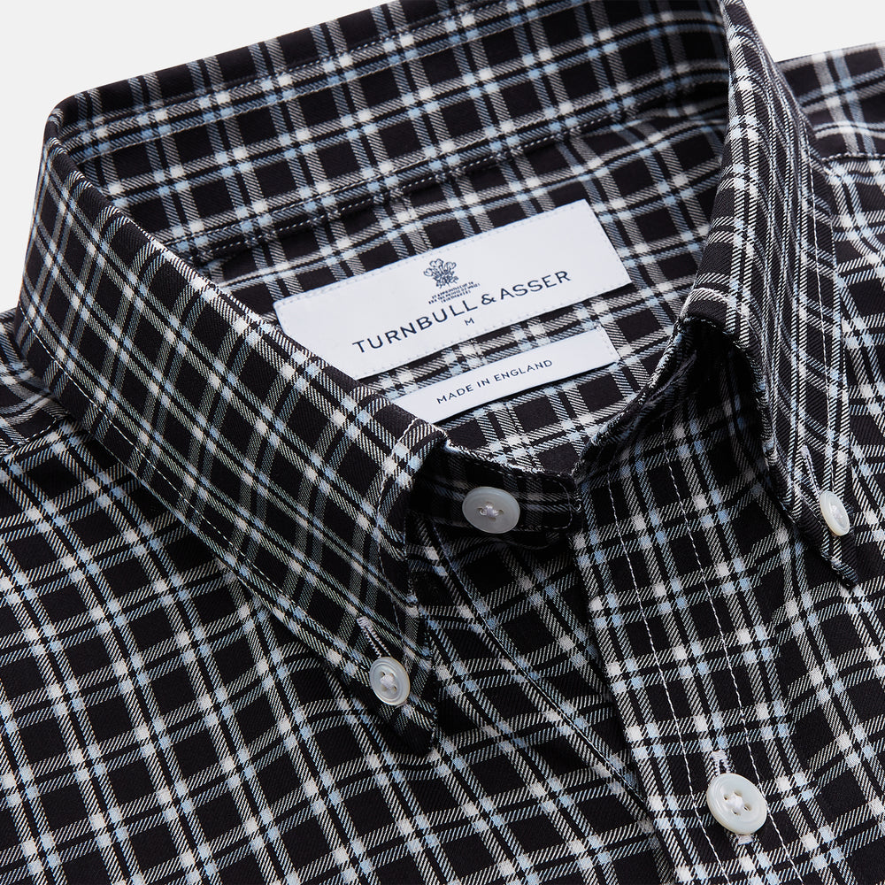 The Turnbull & Asser Black Multi Check Cotton Blend Weekend Fit Hayne Shirt features a Dorset button-down collar and white buttons, with a black and white plaid pattern, shown laid flat on a white background.
