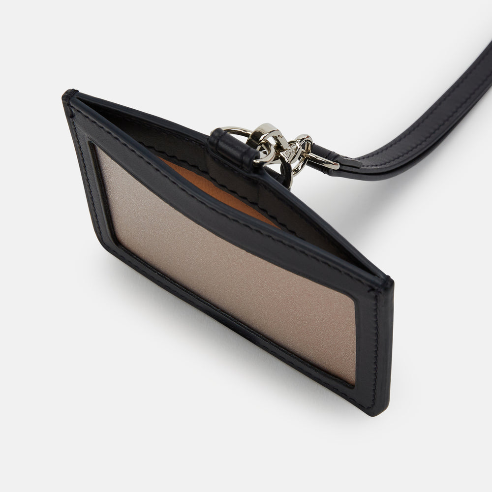 The Turnbull & Asser Navy ID Card Holder is shown with a matching lanyard strap and key cover, all featuring silver hardware, against a plain white background.