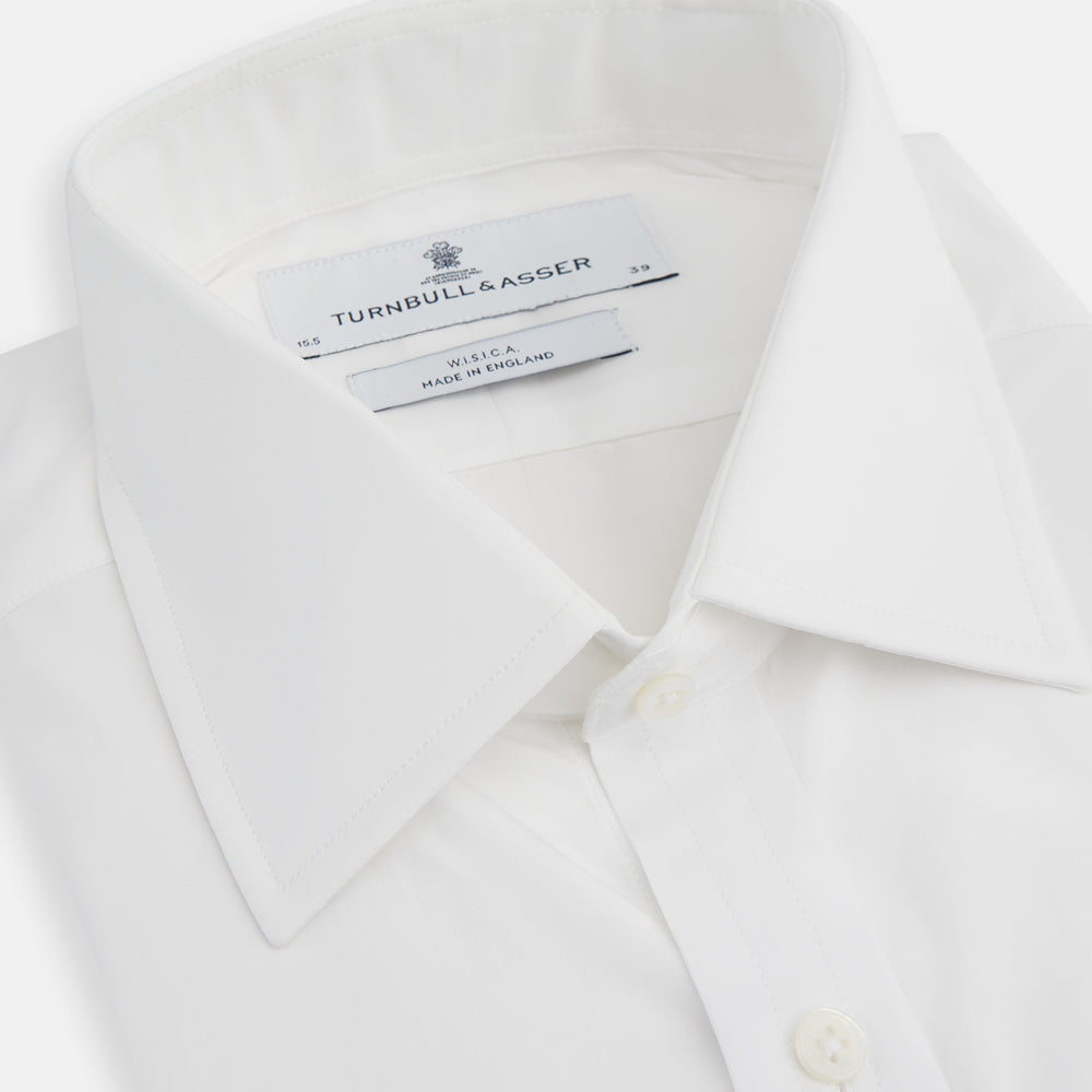 The Turnbull & Asser White West Indian Sea Island Cotton Shirt features a T&A collar, 3-button cuffs, and is crafted from luxurious long-staple cotton for exceptional softness. Displayed against a white background.