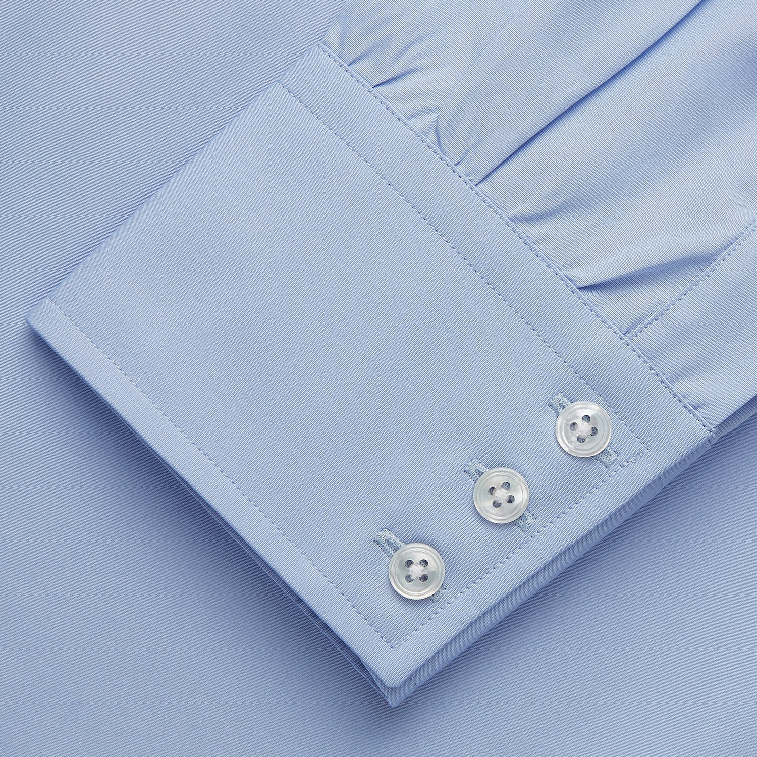View 4 of product Turnbull & Asser's Tailored Fit Blue Cotton Shirt features a Kent collar, 3-button cuffs, and a clean design—ideal with a navy suit. Displayed on a plain white background.