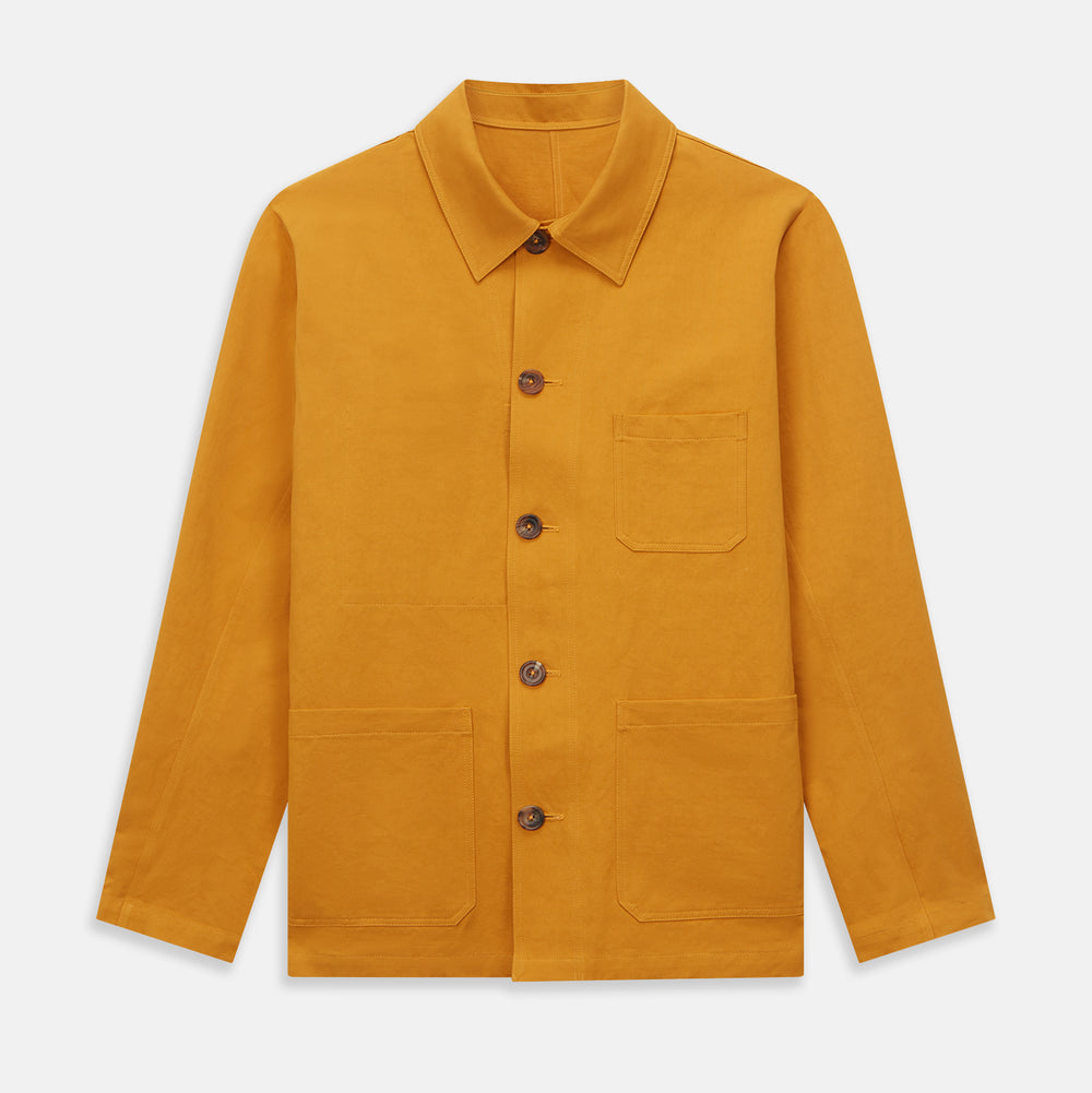 The Turnbull & Asser Ochre Cotton-Linen Remy Chore Jacket features a collar, long sleeves, brown front buttons, and three patch pockets, shown on a plain white background.