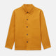The Turnbull & Asser Ochre Cotton-Linen Remy Chore Jacket features a collar, long sleeves, brown front buttons, and three patch pockets, shown on a plain white background.