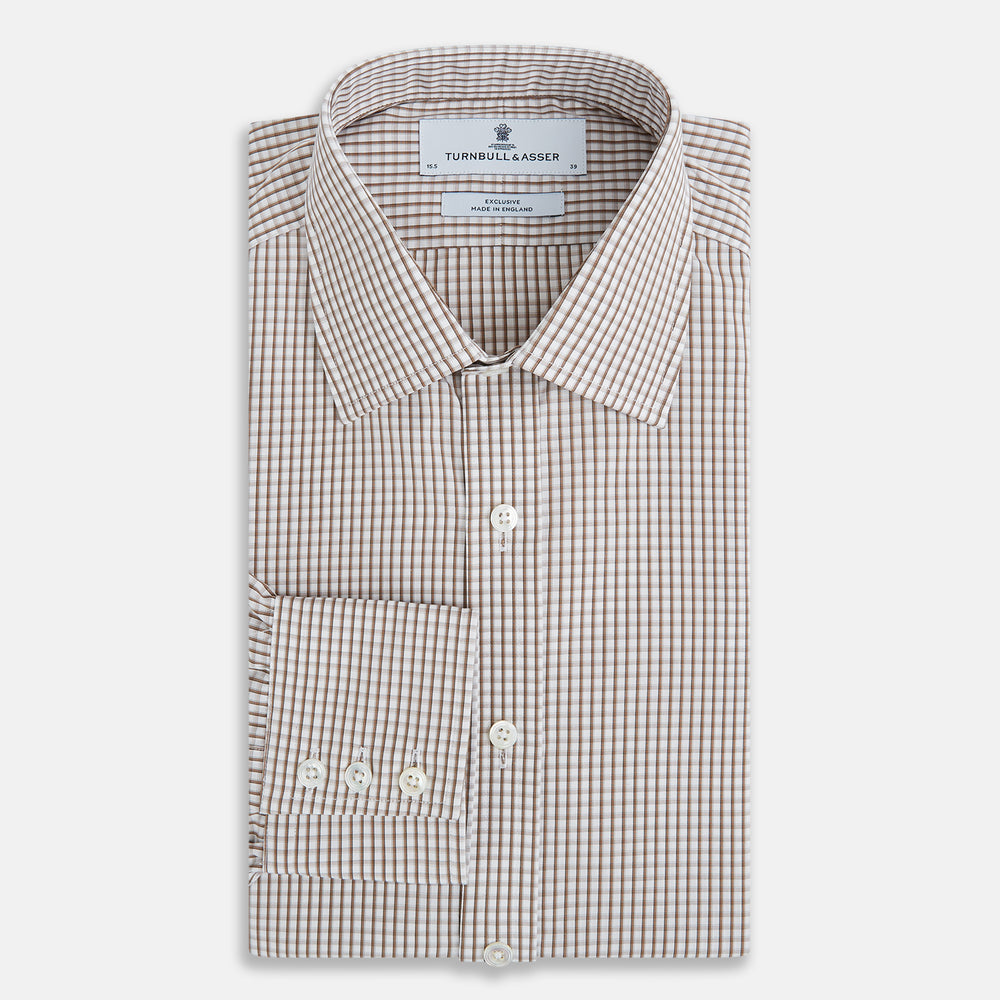 The Coffee Micro Shadow Check Mayfair Shirt by Turnbull & Asser is a long-sleeved, button-up shirt made from fine Italian cotton with a small brown and white check pattern, classic collar, and buttoned cuffs—an essential for any man’s wardrobe.
