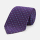 The Turnbull & Asser MINI SQUARE SPOT PLUM BLUE TIE is a luxury English silk necktie in plum, featuring a blue and white grid pattern of small squares, displayed rolled up against a simple light background.