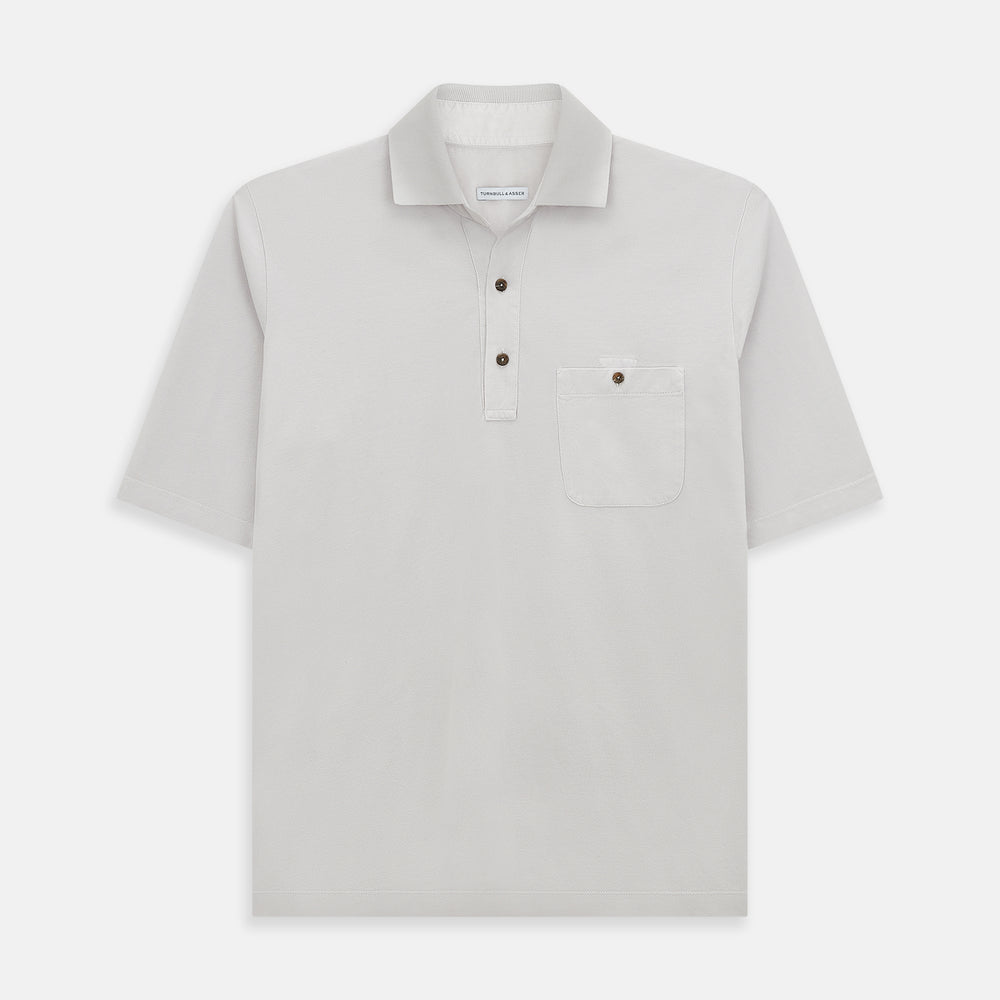 The Turnbull & Asser Pale Pink Polo Shirt is a cotton jersey short-sleeve polo with a collar, three brown buttons on the placket, and a button-flap chest pocket, shown against a white background.
